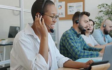 office workers in a meeting wearing headsets